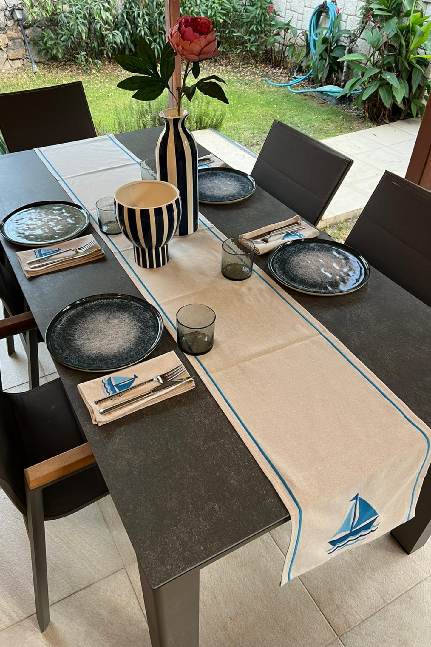 sailboat embroidered napkins and runner on dining table with tableware