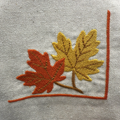 Embroidered design of leaves on napkin