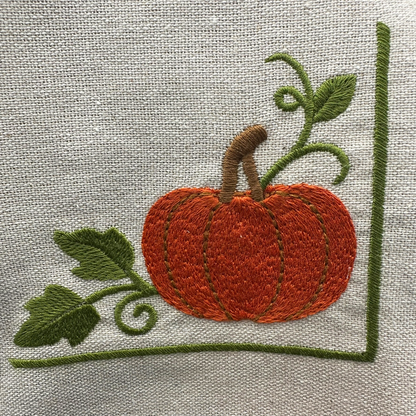Embroidered pumpkin with leaves on a napkin