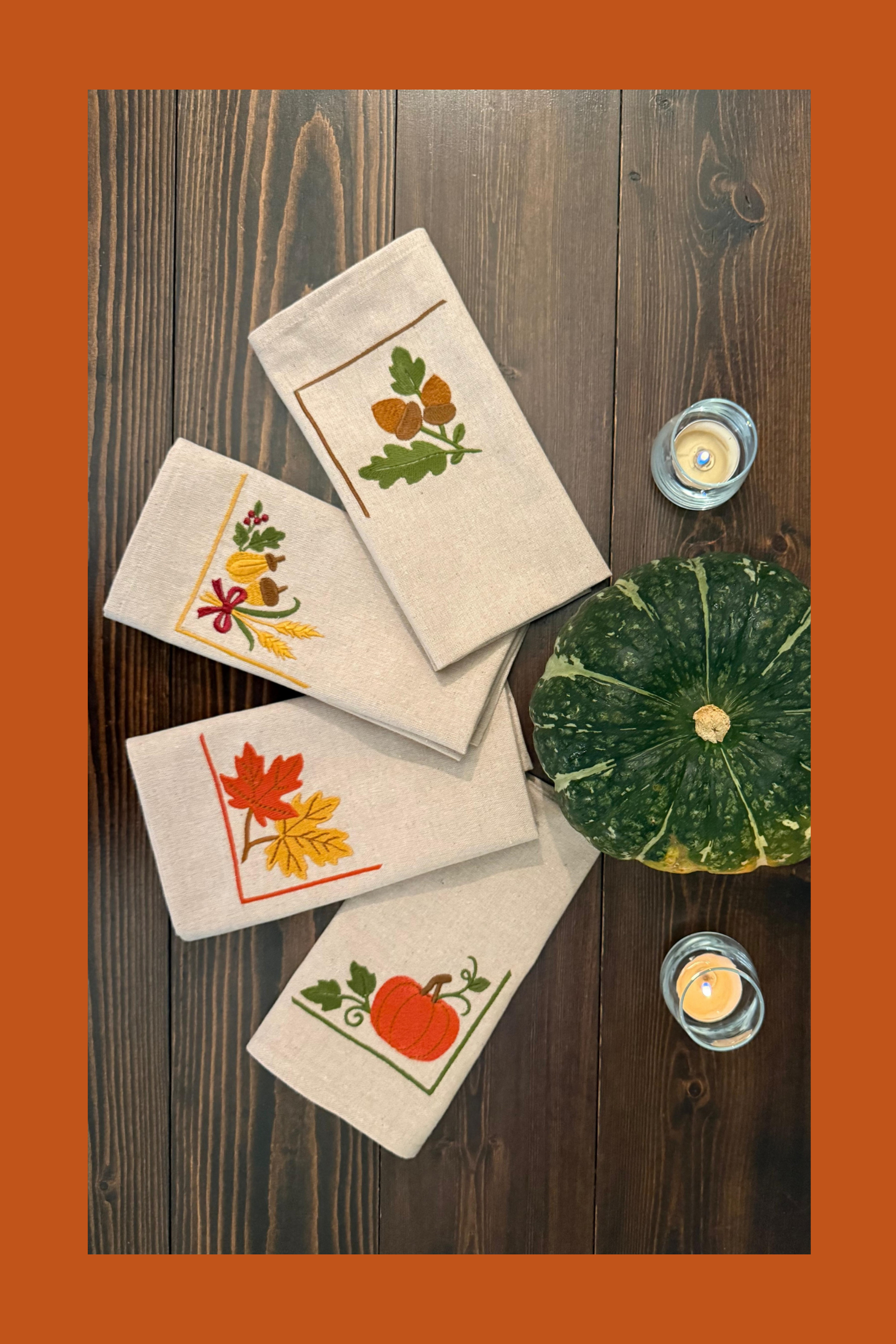 Set of folded embroidered napkins with autumn designs