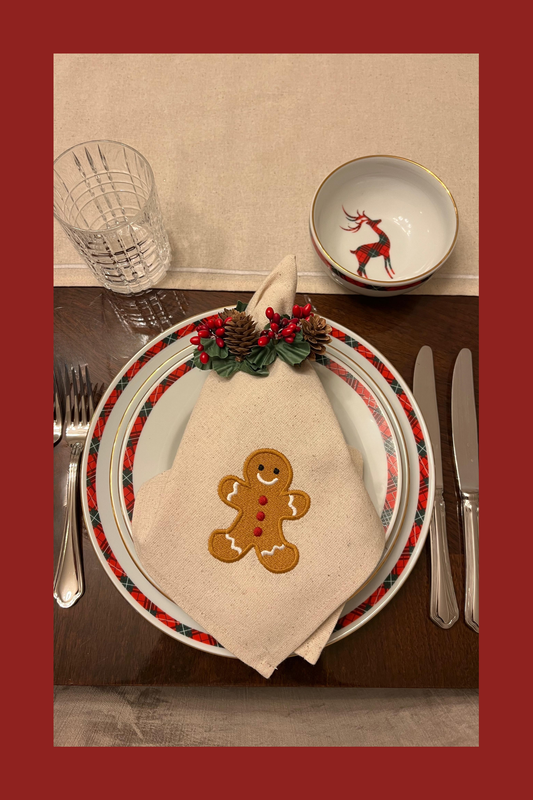 Christmas-themed table setting with gingerbread embroidered napkin