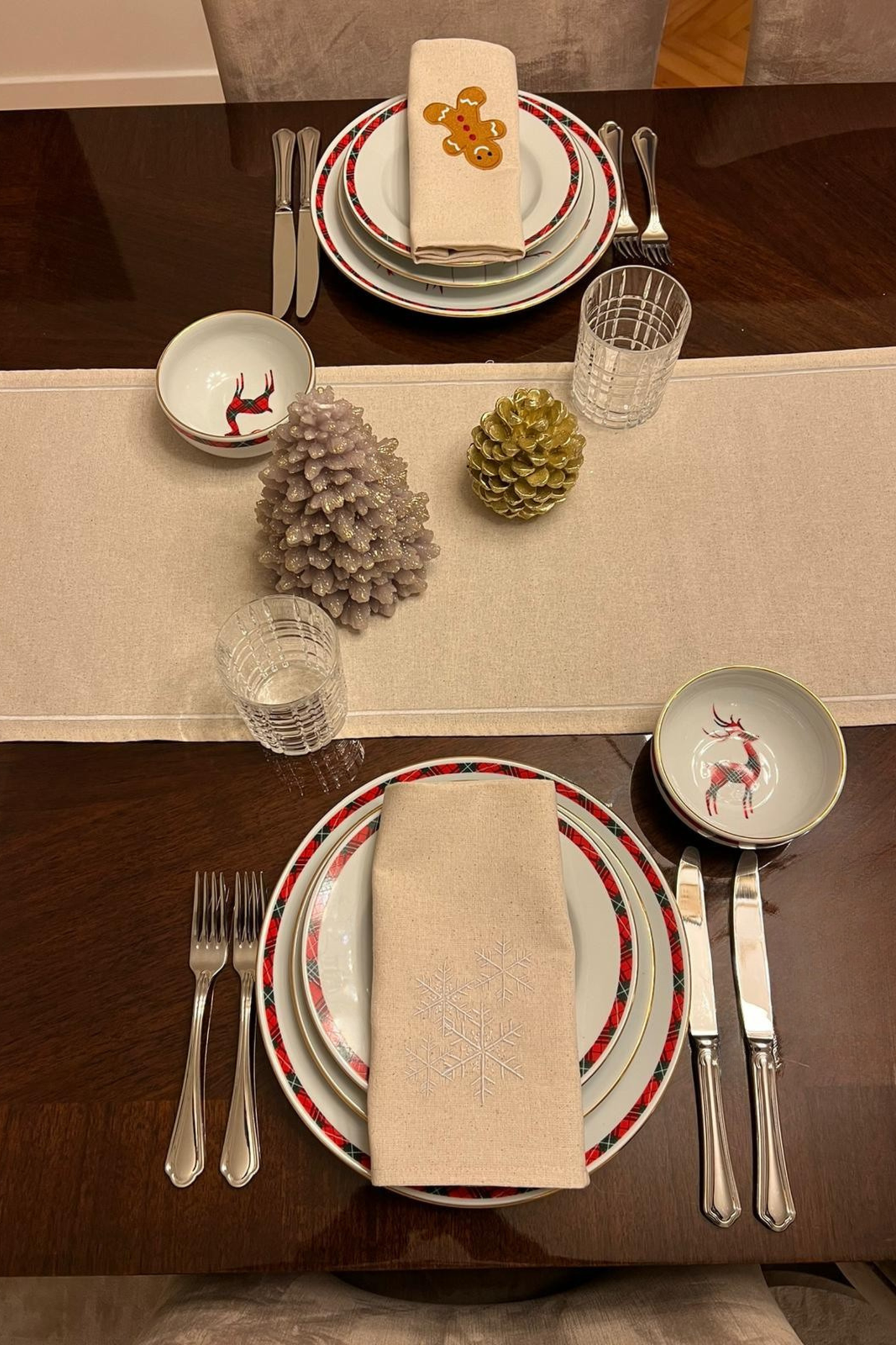 embroidered gingerbread and snowflake napkins on dining table