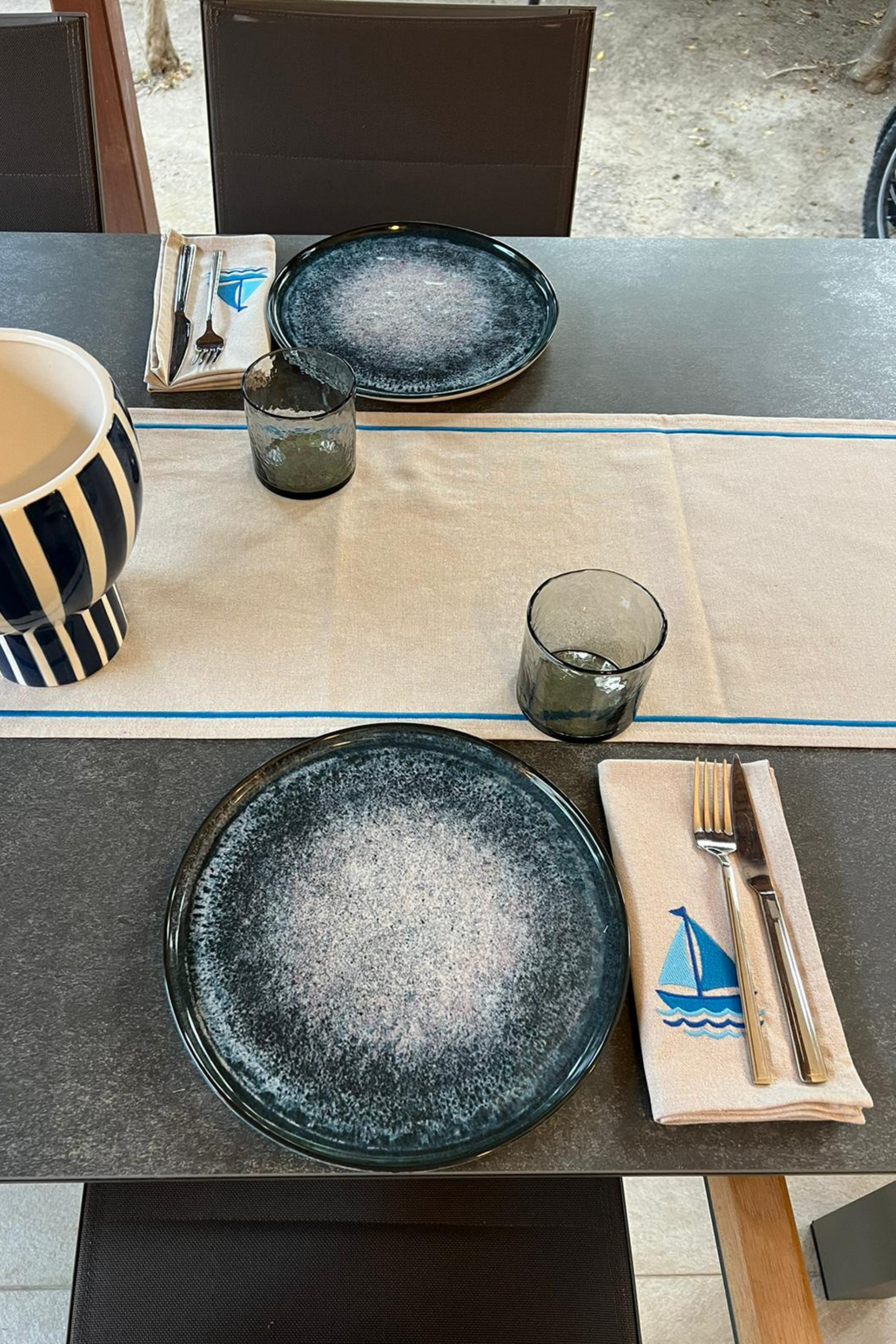 sailboat embroidered napkins on dining table with tableware