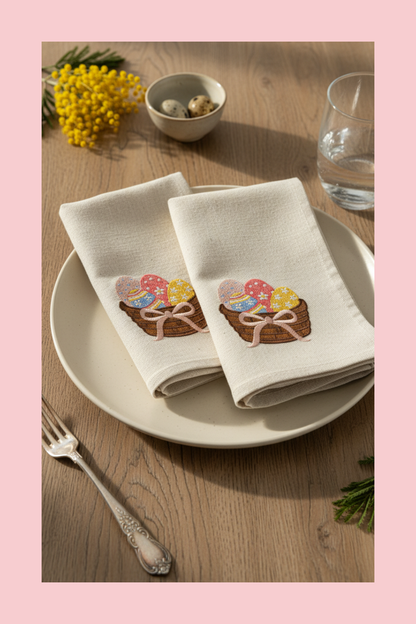 Napkins with Easter-themed design on a plate with a fork and glass of water on a wooden table.